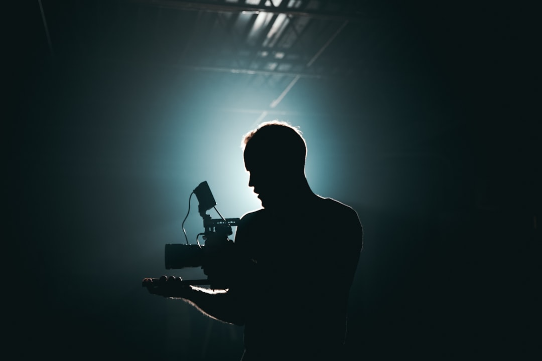 silhouette-photography-of-man-holding-camera-ftqe89f3exa